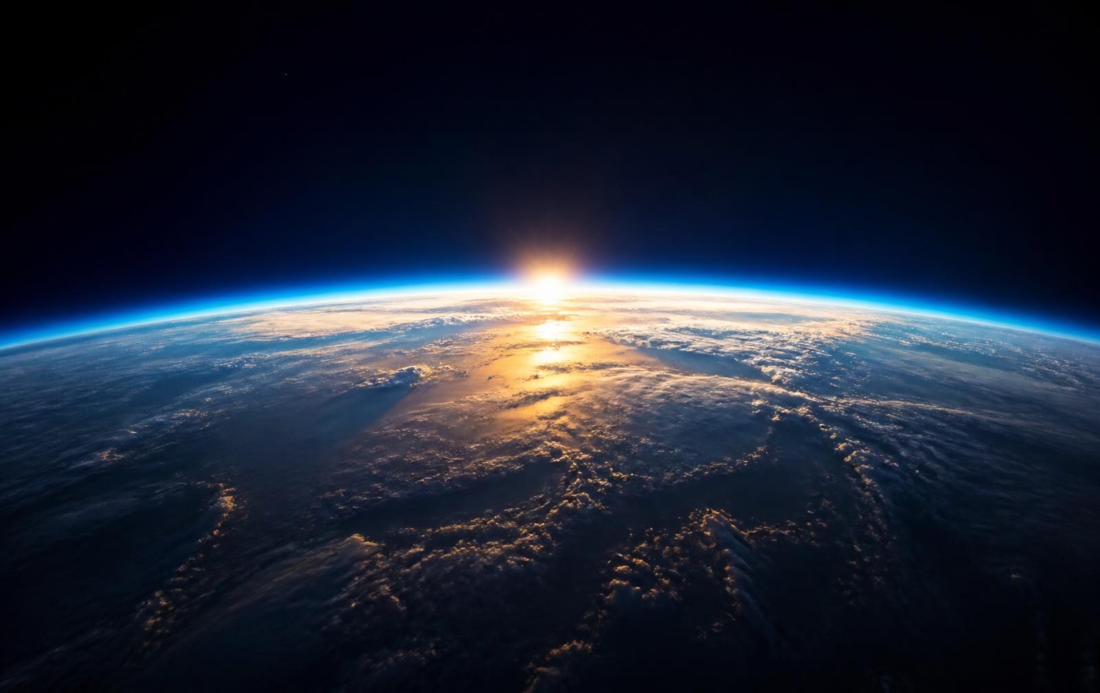 Earth's curved horizon seen from orbit at sunrise